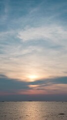 Wall Mural - Sky transform from sunset to a radiant twilight, with beautiful clouds painting the twilight horizon at a beach in the ocean.