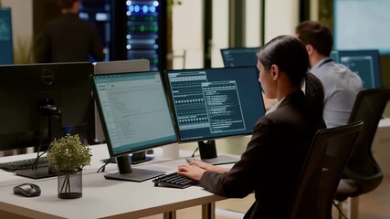 Two system administrators collaborating in a modern data center, inspecting server hardware while analyzing data displayed on computer screens, ensuring optimal performance and security