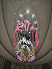 Wall Mural - Large chandelier with many colored lights hanging from it