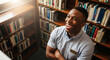 © Milan - Happy young black man laughing in a sunlit library. Joyful African American student surrounded by books.