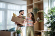 © Migma_Agency - Happy couple arranging belongings in new apartment after moving in
