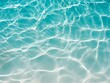 © Oracha - Clear blue water background, reflected ripple across the pool, top view of summer surface of swimming pool with sunlight, design for cosmetic product ,skincare wallpaper