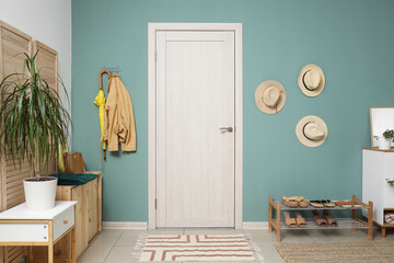 Wall Mural - Interior of stylish hallway with shoe stand, hats and door