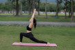 © Wanchai - Asian woman practicing yoga peacefully in the park after work, finding relaxation and balance at sunset.