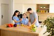 © BGStock72 - Family cooking together in a cheerful kitchen with fresh ingredients