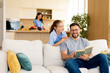 © BGStock72 - Father and daughter share a joyful reading experience in a cozy modern home