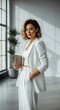 © alisa family - Confident Businesswoman in White Suit and Glasses Holding Clutch Bag in Modern Office