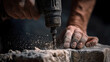 © Anthichada - Close up hands of professional worker using a power hammer to drill a hole in a stone