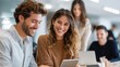 © Nutt - Co-workers Collaboration: Colleagues work on a tablet in a modern office setting, collaborative workspace, a perfect blend of professionalism, and teamwork.