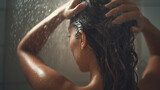 Back view of a woman applying shampoo while washing her head in bathroom. Taking shower and enjoying time, Body and hair hygiene, lifestyle concept