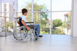 © New Africa - Teenage boy in modern wheelchair indoors, space for text