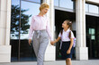 © sofiko14 - A mother and daughter walk hand-in-hand, likely heading to or from school.