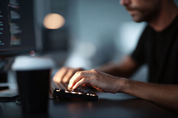 Focused image of a programmer coding at night. Concept for development, technology, cybersecurity, or remote work. Evokes concentration and modern lifestyle.