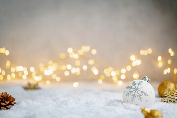 Wall Mural - christmas holiday background with snow, fir tree and decorations with christmas light behind. christ