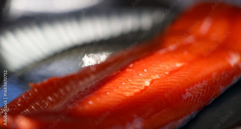 Vibrant red meat on a raw fillet of fresh caught wild Coho Salmon. The ...