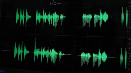 Digital audio waveform timeline on screen with markers and grid lines. Audio waveform on display screen