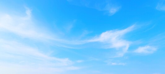 Wall Mural - Panorama view of bright blue sky with fluffy white clouds on a clear sunny day. Sky panorama clear blue with white clouds in spring. Cloudscape. Clear blue sky, bright spring, wallpaper landscape.