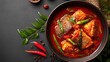 © ArtKom - Spicy asian fish curry with vegetables in rich red sauce
