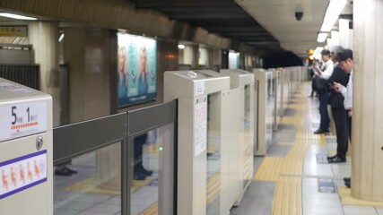 Canvas Print - blur out of focusing view of subway underground platform with passenger waiting for upcoming arrival train in rushhour,tokyo japan public train transportation life