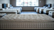 © Detective - Comfortable orthopedic mattress with quilted surface displayed in a bright modern showroom with multiple beds for sale