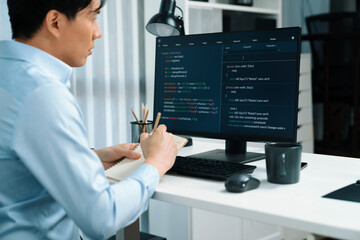 Smart IT developer looking at coding program application on computer screen of online website, analyzing intelligent database system development on business world market at modern office. Infobahn.