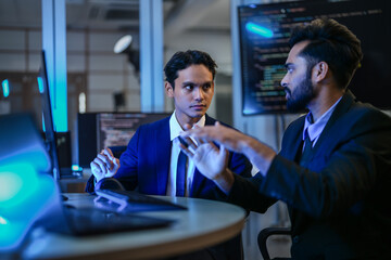 diverse ai developers collaborate in a late-night coding session. a senior engineer mentors his coll
