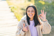 © luismolinero - Young woman at outdoors With glasses and doing OK sign