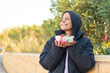 © luismolinero - Young woman  holding a bowl of fruit at outdoors