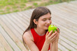 © luismolinero - Young pretty woman at outdoors holding an apple