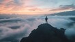 © Alexander - A lone figure stands atop a rocky peak, gazing out at a sea of clouds during a vibrant sunrise or sunset.