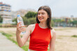 © luismolinero - Young pretty Ukrainian woman with a bottle of water at outdoors with happy expression