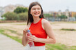 © luismolinero - Young pretty Ukrainian woman with a bottle of water at outdoors