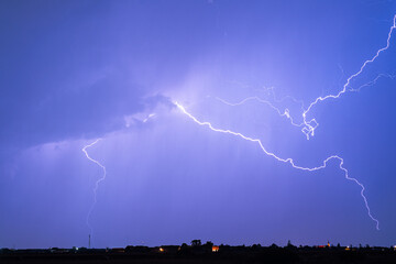 Wall Mural - thunderbolts of lightning over a high plain near the town of gheorgheni in the carpathian mountains,
