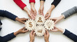 © Kaluya Stock - Multiethnic business people collaboratively holding interconnected wooden gears with business icons (growth, finance, idea, people), symbolizing teamwork and shared strategy