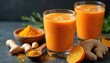 © miss irine - Bright orange carrot ginger smoothie served in glasses on dark background. Garnished with orange slices grated ginger. Healthy fresh beverage rich vitamin C. Vegan detox drink for wellness, immune