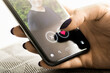 © terovesalainen - Date app. Woman and love. Online romance scam. Cheating, swiping right or stalker. Profile picture of a man. Virtual relationship. Finger and heart.