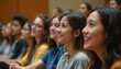 © miss irine - Group of young students, diverse group of people, attends college orientation session in lecture hall. Happy faces, positive atmosphere during educational event. People listen to lecture attentively.