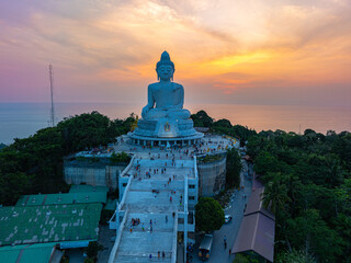 Wall Mural - aerial view bright yellow sun in sunrise at Phuket big Buddha. the sun breaks through the clouds and illuminates the Buddha statue that atop the mountain.
Sunrise with amazing light rays effects.