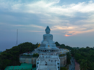 Wall Mural - aerial view Phuket big Buddha in beautiful sunset.
the sun shines through the clouds impact on ocean surface
The beauty of the statue fits perfectly with the charming nature.
cloud scape background.