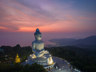 Wall Mural - aerial view Phuket big Buddha in beautiful sunset.
the sun shines through the clouds impact on ocean surface
The beauty of the statue fits perfectly with the charming nature.
cloud scape background.