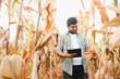 © Serhii - young indian farmer at corn field
