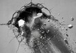 © FOYJUL - A hole is blasted through a concrete wall, sending debris flying in a powerful explosion