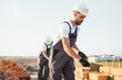 © Serhii - Man bricklayer installing bricks on construction site