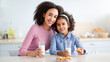 © Prostock-studio - Healthy Breakfast. Cute Little African American Girl And Her Beautiful Young Mother Drinking Milk From Glasses, Eating Cookies. Woman Embracing Her Happy Daughter. Time For Vitamins And Nutrition