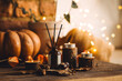 © ArtSys - Aroma reed diffuser, pumpkins, knitted warm sweaters, candles, dry leaves on wooden table. Concept of house decor, apartment seasonal fragrance. Thanksgiving. Autumn mood, cozy fall home atmosphere