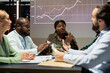 © DC Studio - African american supervisor discuss budgeting forecast with the team, sharing ideas and working on efficient resources allocation to ensure global success. Establishing enterprise goals after hours.