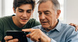 © Anisgott - Teenage Boy Teaching Grandfather to Use Smartphone in Bright Living Room