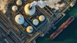 © Kosin - Aerial view of oil refinery featuring large storage tanks and cargo ship docked nearby, showcasing industrial activity and environmental impact