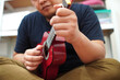 © airdone - Asian man playing ukulele at home