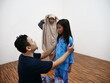 © airdone - Asian muslim father put on clothes to his daughter to do salah prayer, preparation for islamic pray
